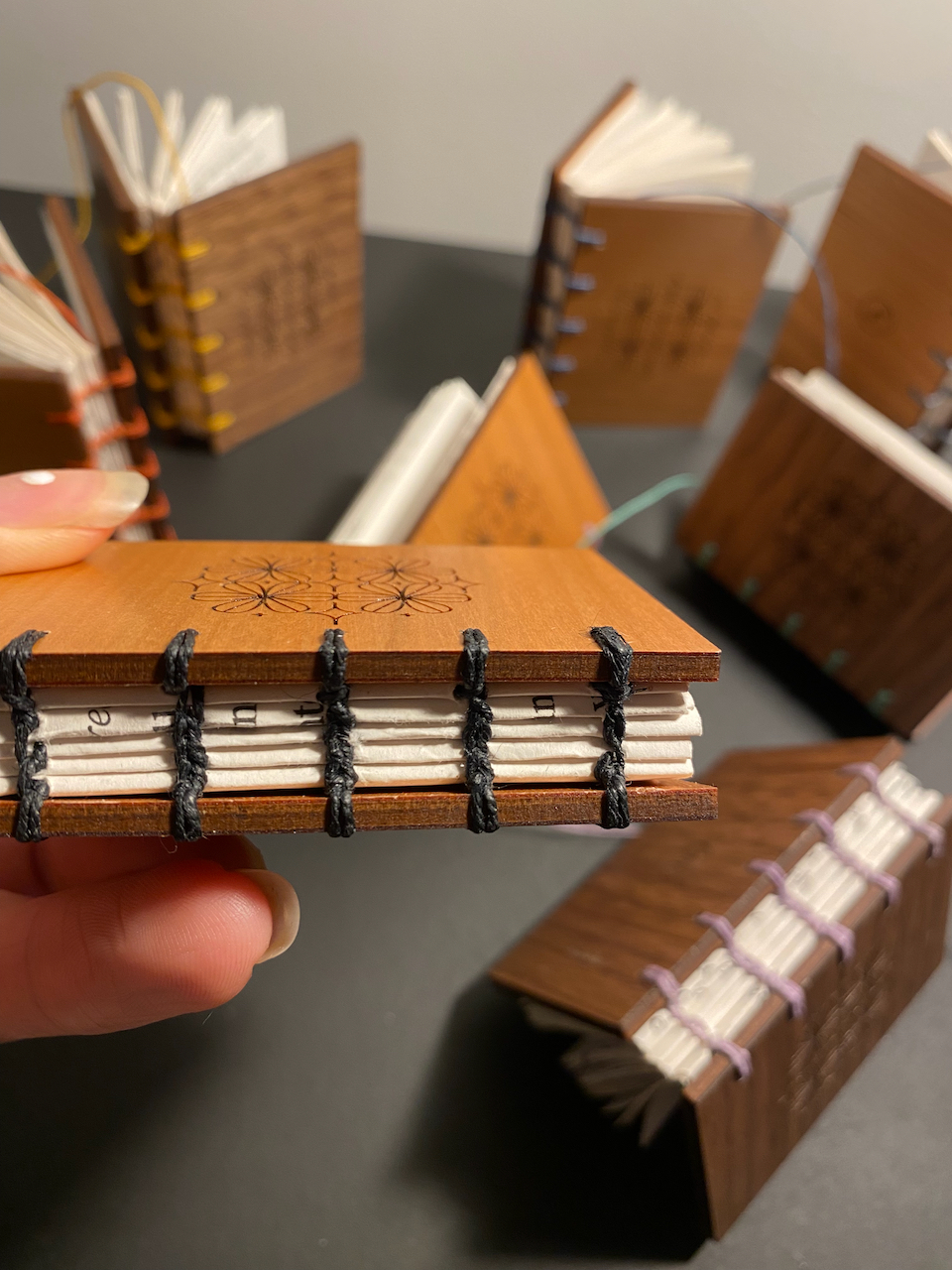 Mini book decorations that I make using wood offcuts and paper mis-prints. They are 1/3 of a real Fondfolio book.